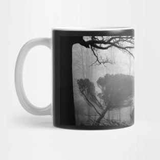 Leaning pine in a foggy wood Mug